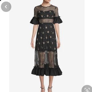 Sheer cutout dress with puff sleeves. Haute Rogue